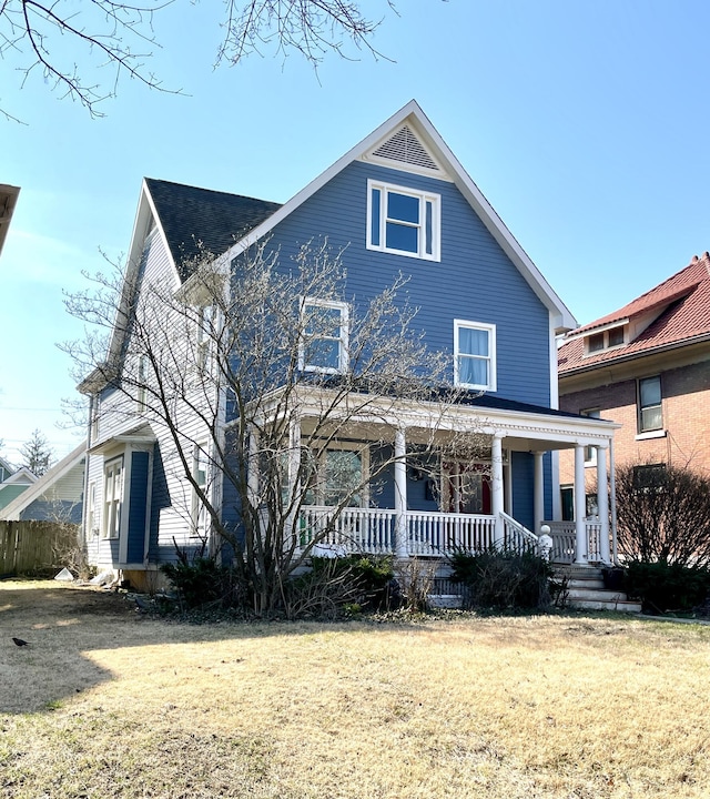 view of front of property with a porch and a front yard