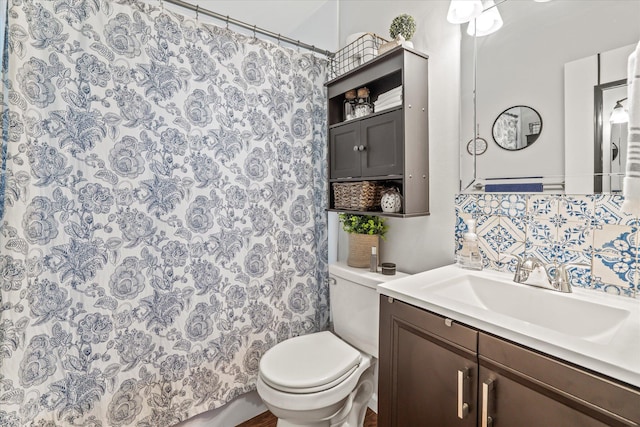 bathroom with a shower with curtain, vanity, and toilet