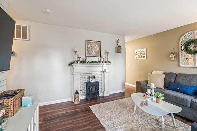 living room with dark wood-type flooring and a wood stove