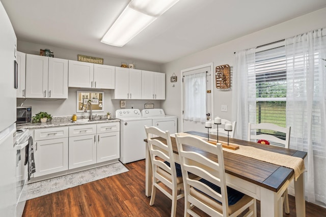 kitchen featuring white electric range, white cabinetry, separate washer and dryer, sink, and dark wood-type flooring