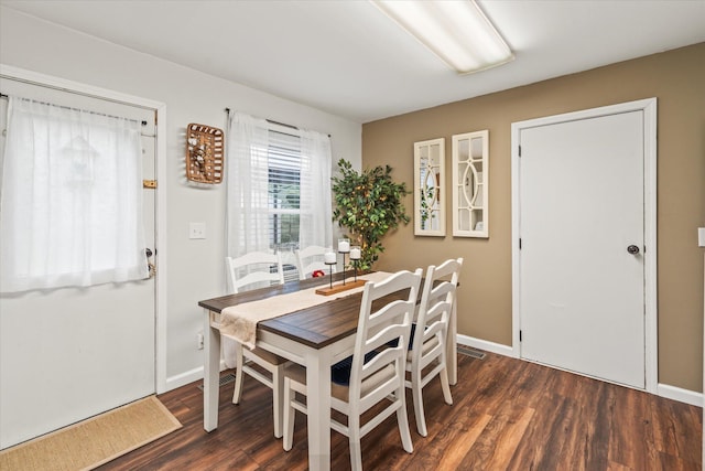 dining space with dark hardwood / wood-style flooring