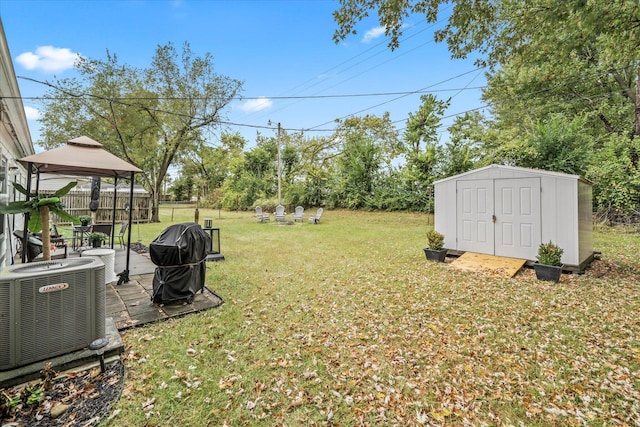 view of yard with a gazebo, central AC, and a storage unit