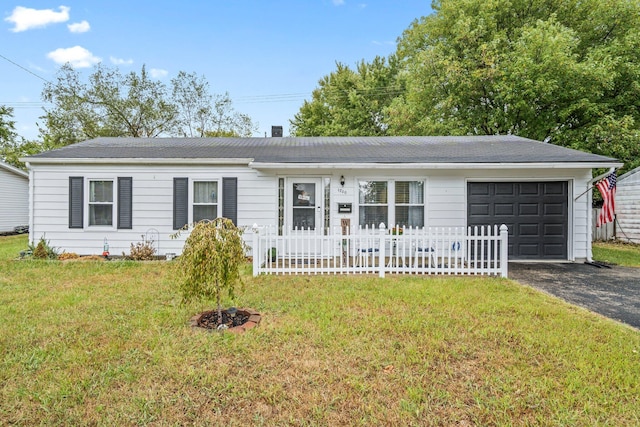 ranch-style home with a garage and a front lawn