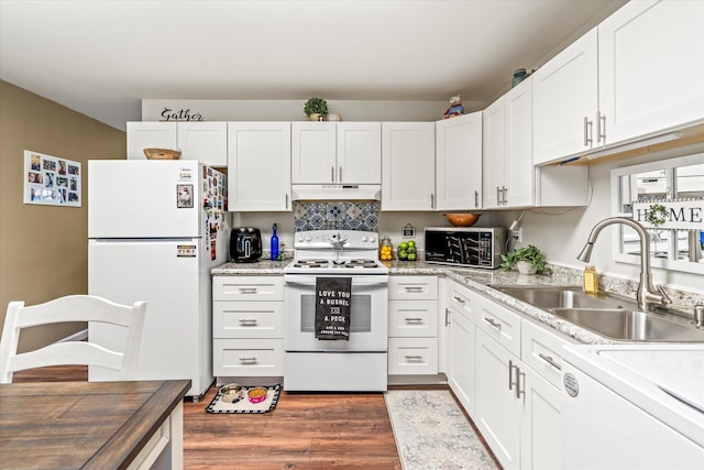 kitchen with dark wood-type flooring, sink, light stone counters, white appliances, and white cabinets