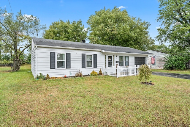 single story home featuring a garage and a front yard