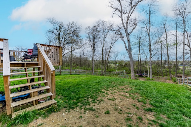 view of yard featuring fence, stairway, and a deck
