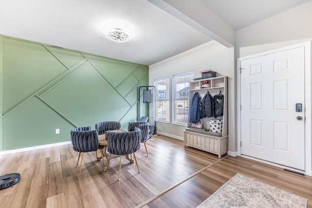 living area with wood finished floors and baseboards