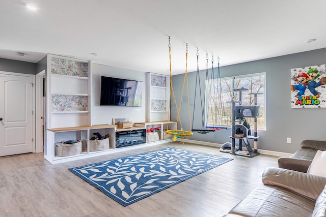 living area featuring baseboards and wood finished floors