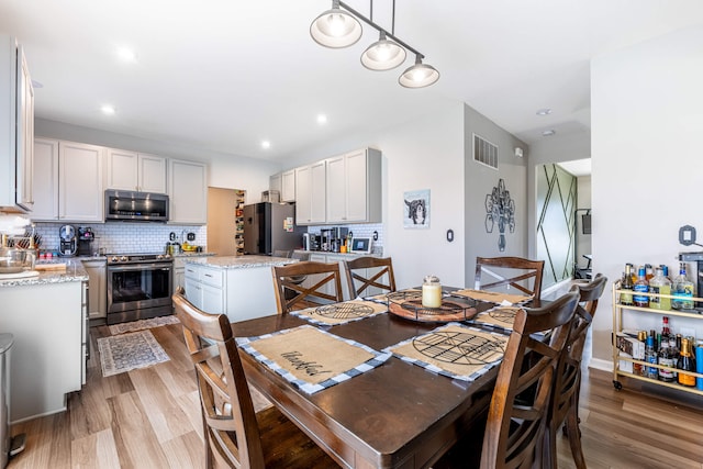 dining room featuring visible vents, recessed lighting, and light wood finished floors
