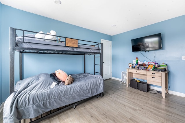 bedroom featuring wood finished floors and baseboards