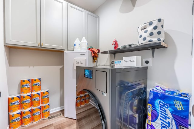 laundry area with washer / clothes dryer, visible vents, light wood-style floors, ceiling fan, and cabinet space
