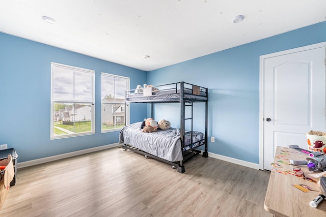 bedroom with baseboards and wood finished floors