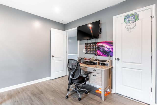 home office featuring baseboards and light wood-style flooring
