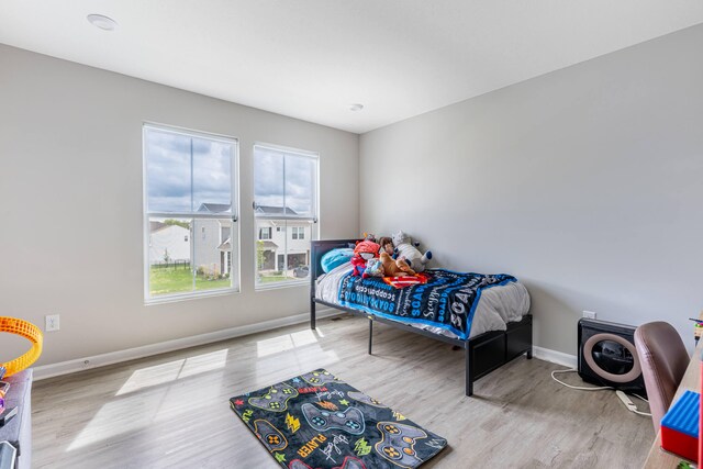 bedroom with wood finished floors and baseboards