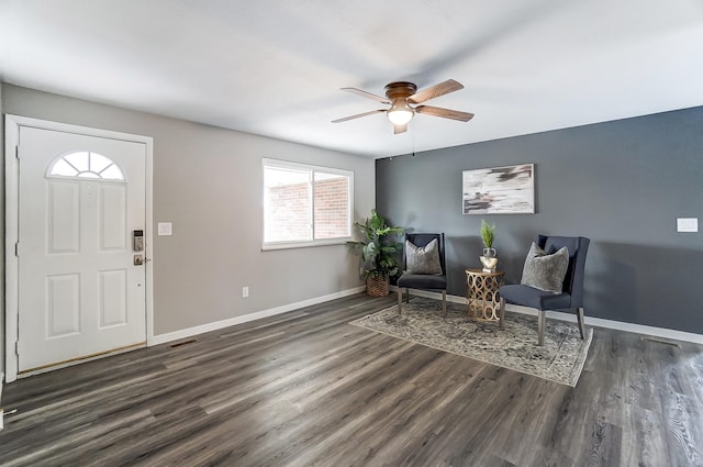 foyer entrance featuring a ceiling fan, dark wood-style flooring, visible vents, and baseboards