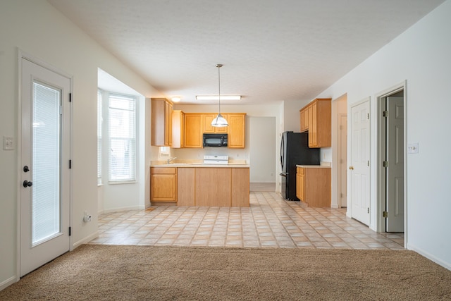 kitchen with sink, hanging light fixtures, light brown cabinets, light colored carpet, and black appliances