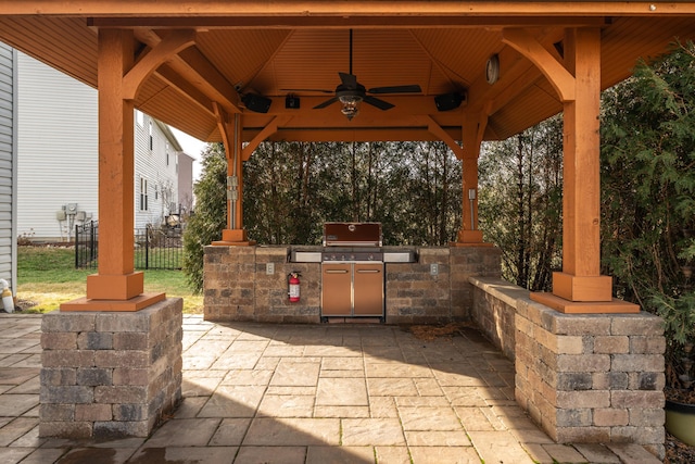 view of patio featuring a gazebo, an outdoor kitchen, area for grilling, and ceiling fan