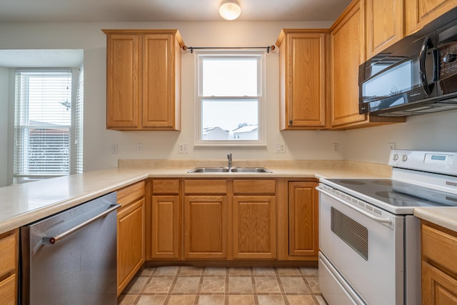 kitchen with electric stove, sink, kitchen peninsula, and dishwasher