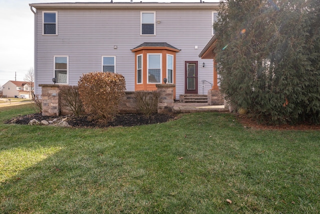 rear view of house with a lawn