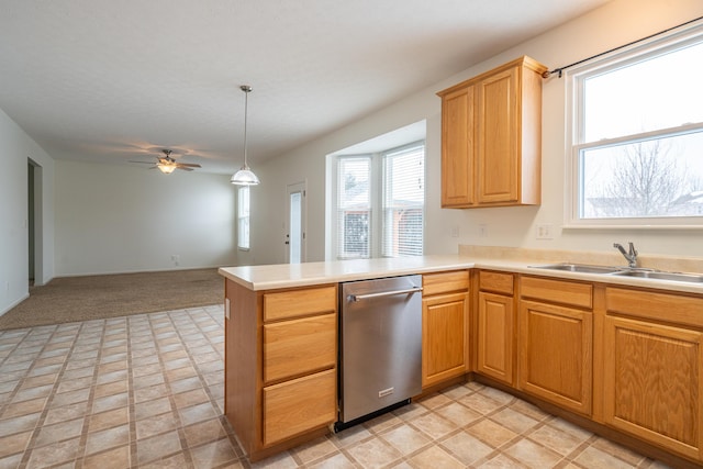 kitchen featuring sink, dishwasher, ceiling fan, hanging light fixtures, and kitchen peninsula