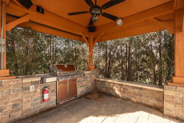 view of patio / terrace with an outdoor kitchen and ceiling fan