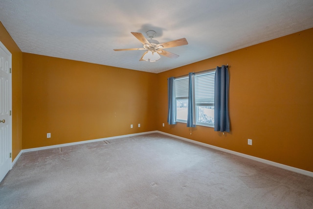 spare room with carpet and ceiling fan