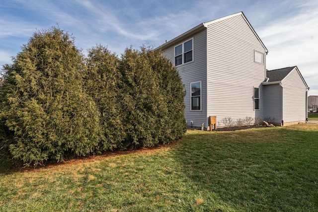 view of side of home featuring a yard