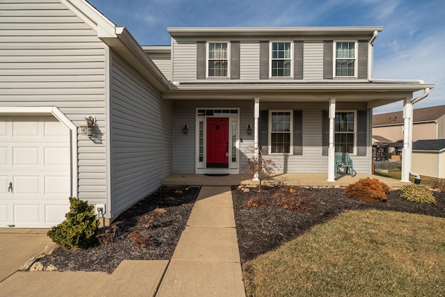 view of front of home featuring a garage, a front lawn, and a porch