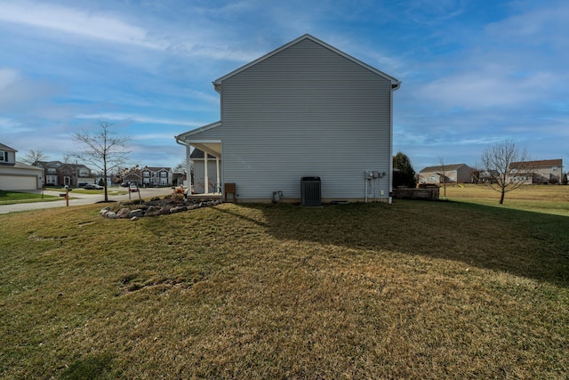 view of property exterior featuring a yard and central AC unit