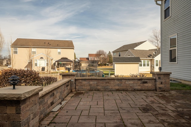 view of patio / terrace with a storage unit and a trampoline