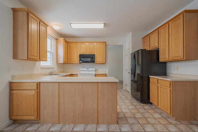 kitchen with sink, black appliances, kitchen peninsula, and light brown cabinets