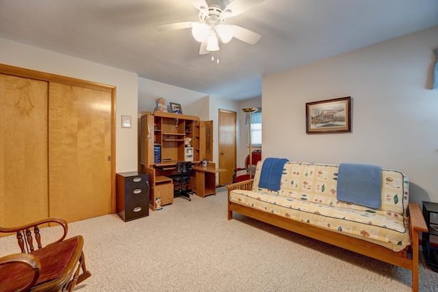 living area with carpet flooring and a ceiling fan