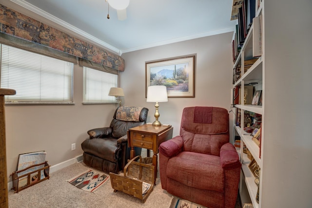 sitting room with ceiling fan, baseboards, carpet floors, and ornamental molding