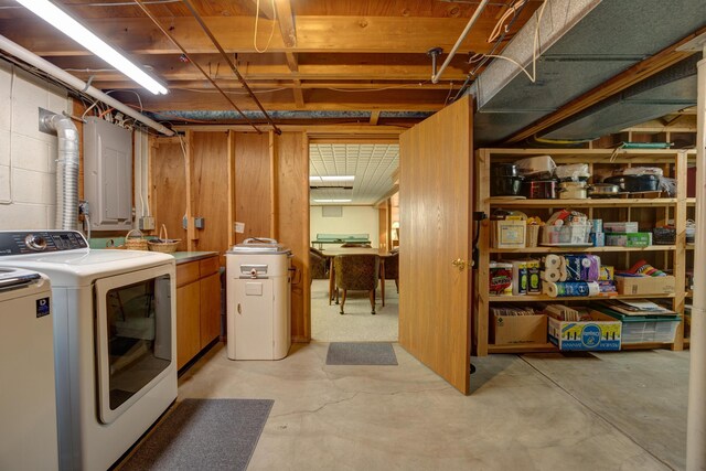 laundry room featuring laundry area, concrete block wall, and washing machine and clothes dryer