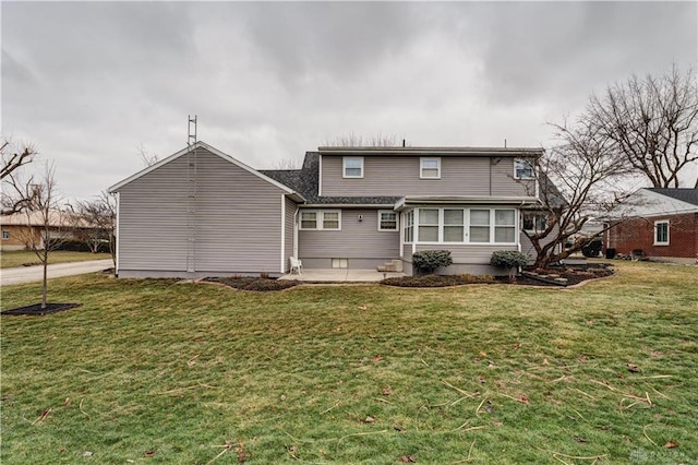 back of property featuring a yard, a sunroom, a patio area, and entry steps