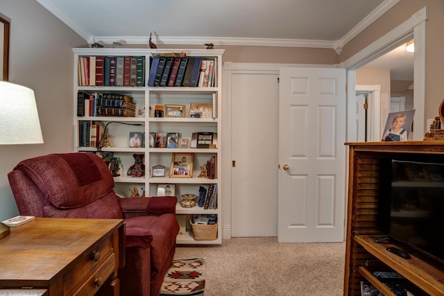 sitting room with carpet floors and ornamental molding