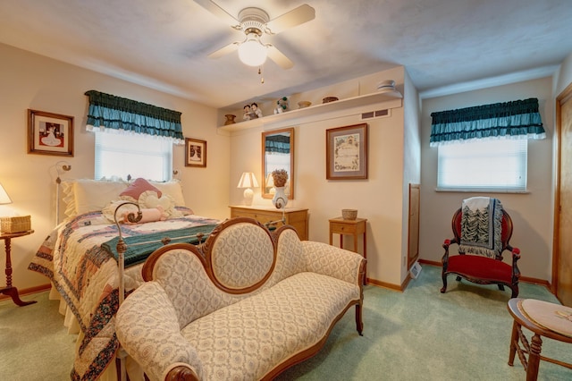 carpeted bedroom featuring baseboards and a ceiling fan