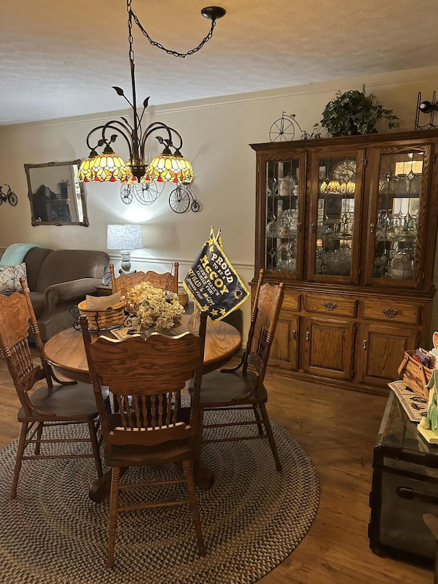 dining space featuring a notable chandelier and dark hardwood / wood-style flooring