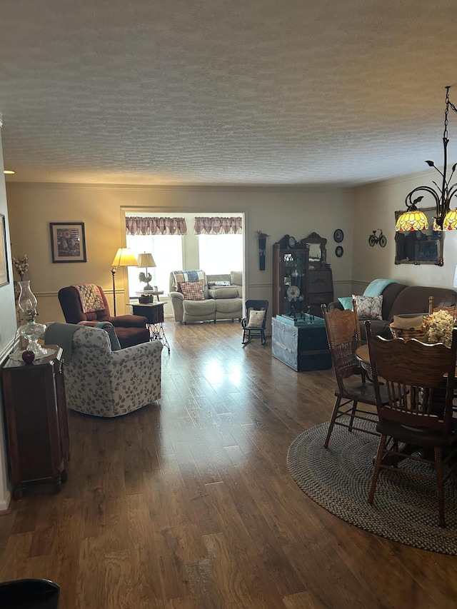 living room with dark hardwood / wood-style floors and a textured ceiling