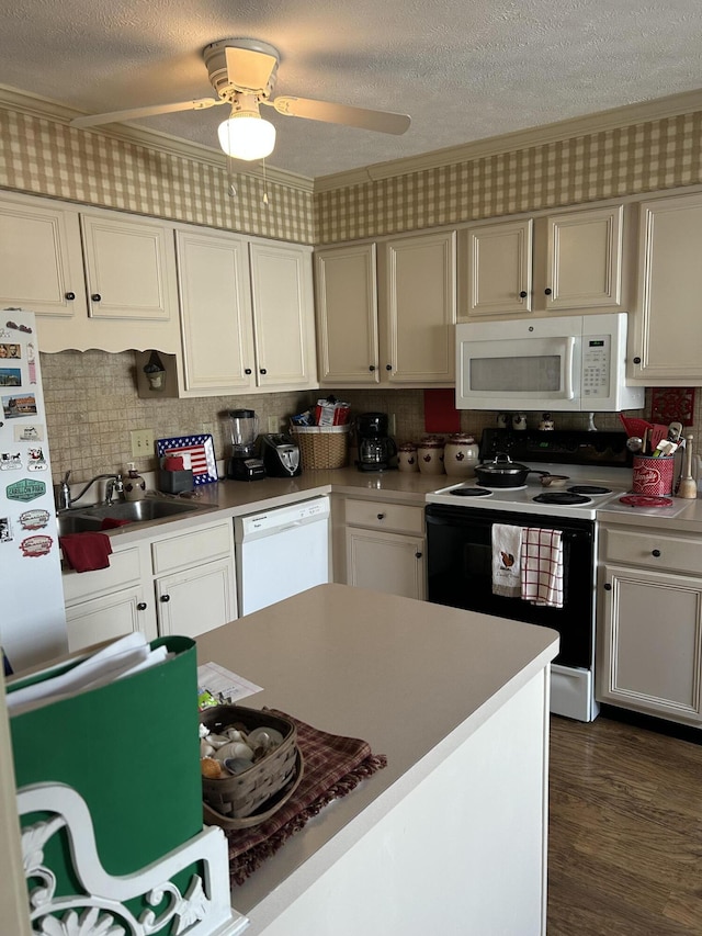 kitchen featuring sink, dark wood-type flooring, a textured ceiling, and white appliances