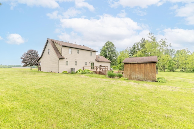 9162 Township Road 169 N, West Liberty, OH 43357 - view of green lawn with a deck, central AC, and an outdoor structure