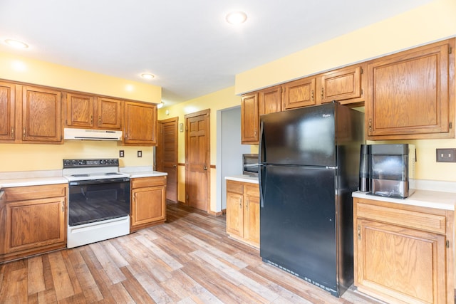 9162 Township Road 169 N, West Liberty, OH 43357 - kitchen featuring range with electric stovetop, freestanding refrigerator, range hood, stainless steel microwave, and light countertops