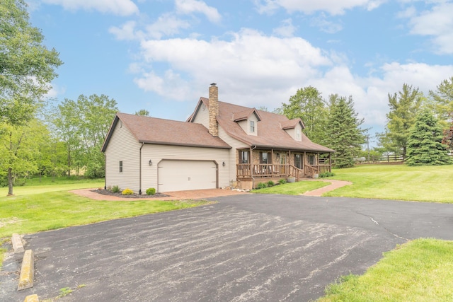 9162 Township Road 169 N, West Liberty, OH 43357 - cape cod-style house featuring a porch, an attached garage, a chimney, driveway, and roof with shingles