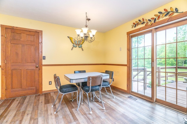 9162 Township Road 169 N, West Liberty, OH 43357 - dining space featuring wood finished floors, a chandelier, and baseboards