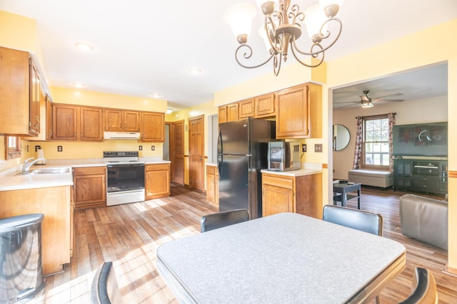 9162 Township Road 169 N, West Liberty, OH 43357 - kitchen featuring range with electric cooktop, a sink, ventilation hood, freestanding refrigerator, and light wood-style flooring