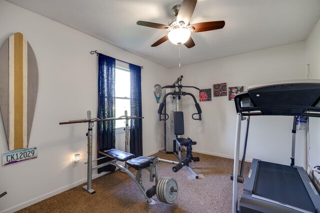 workout area with baseboards, carpet, and ceiling fan
