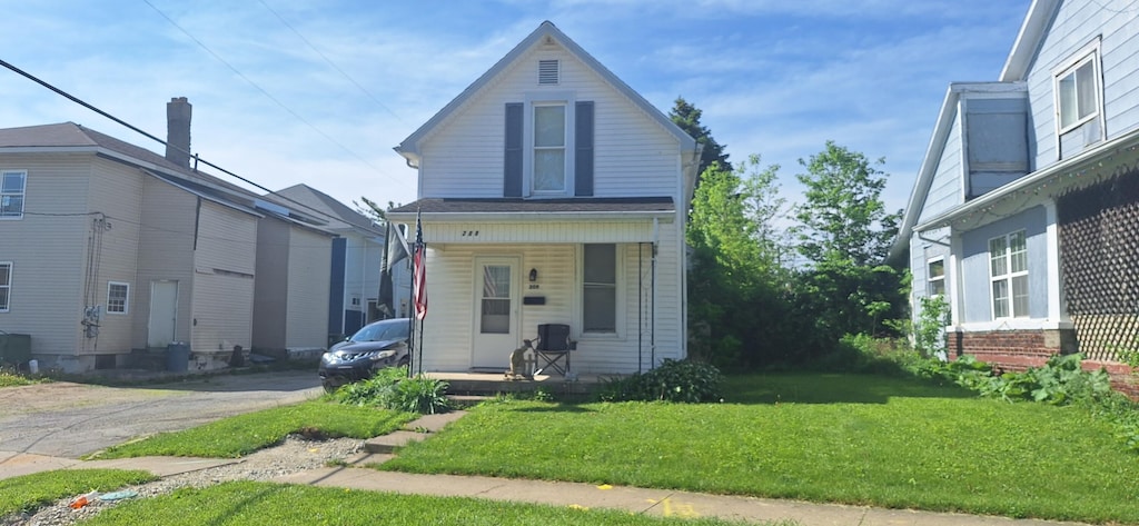 209 Pike St, Sidney, OH 45365 - view of front facade featuring a porch and a front lawn