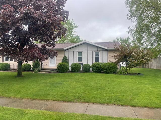 view of front of property with fence and a front yard