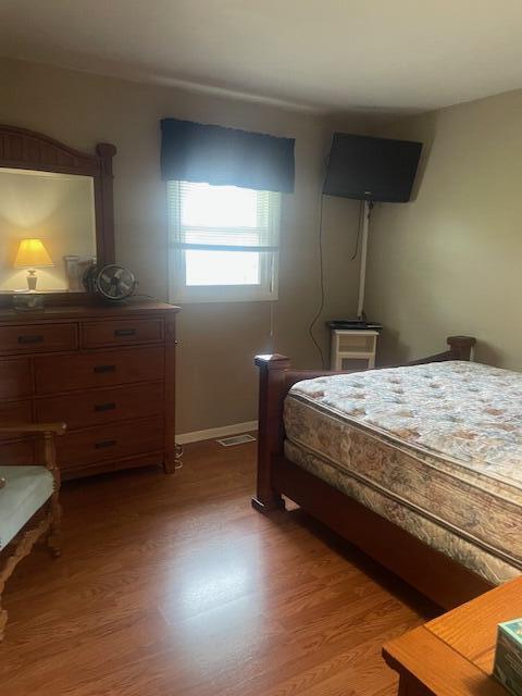 bedroom with baseboards and light wood-style flooring