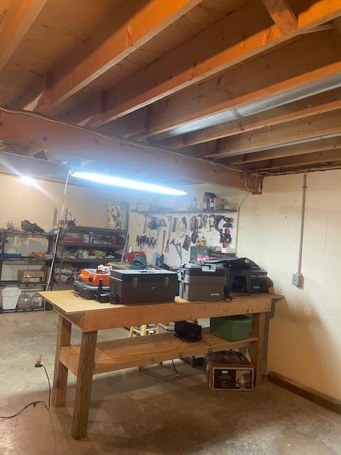 unfinished below grade area with a workshop area